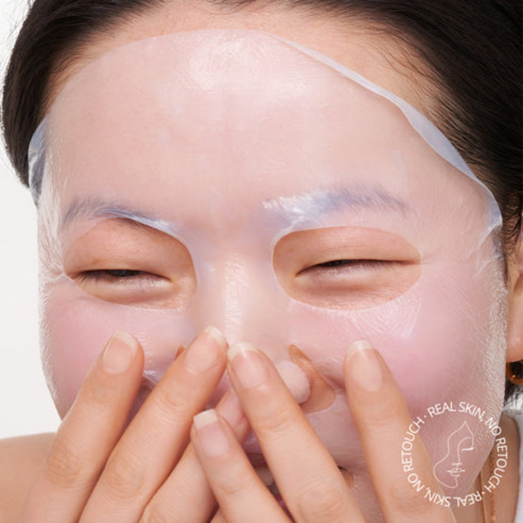 a model applying the mask to her face