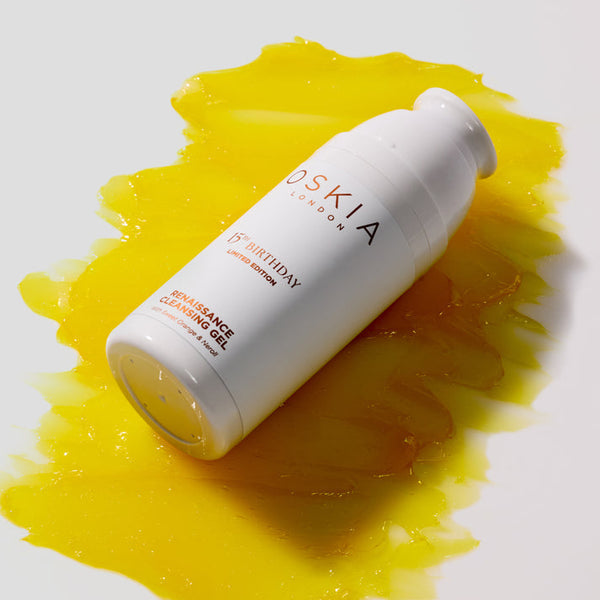 Oskia skincare product with yellow liquid on a white background