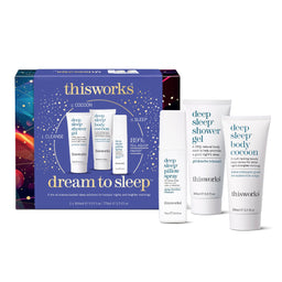 Thisworks 'Dream to Sleep' gift set featuring a blue box with gold and white text, alongside four white and blue skincare tubes and bottles including shower gel, body cocoon, and pillow spray.