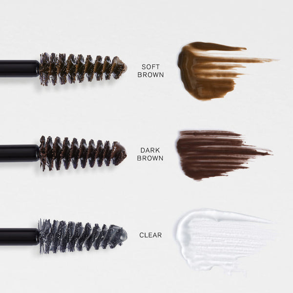 Brow products with bristle brushes and color swatches labeled 'Soft Brown', 'Dark Brown', and 'Clear' on a white background.