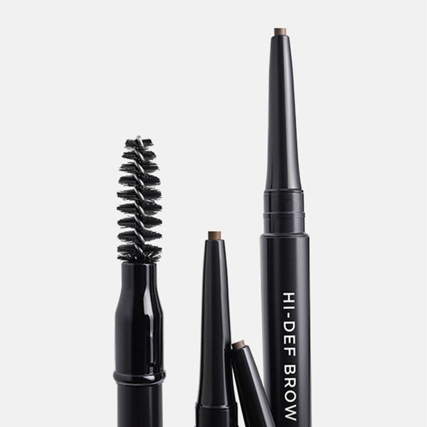 Set of black eyebrow pencils on a light gray background