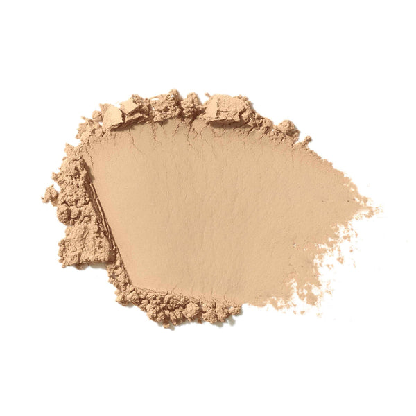 Beige makeup powder on a white background