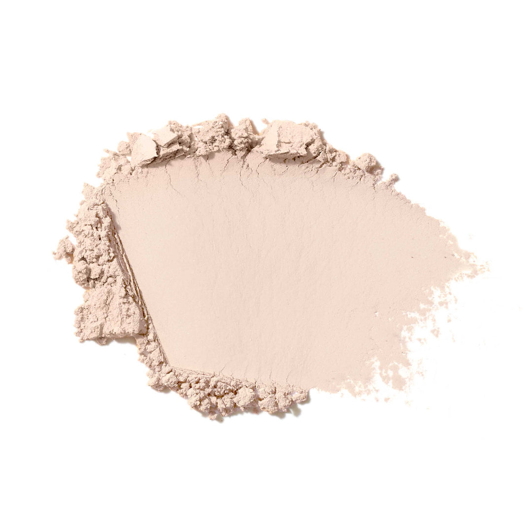 Light pink makeup powder on a white background