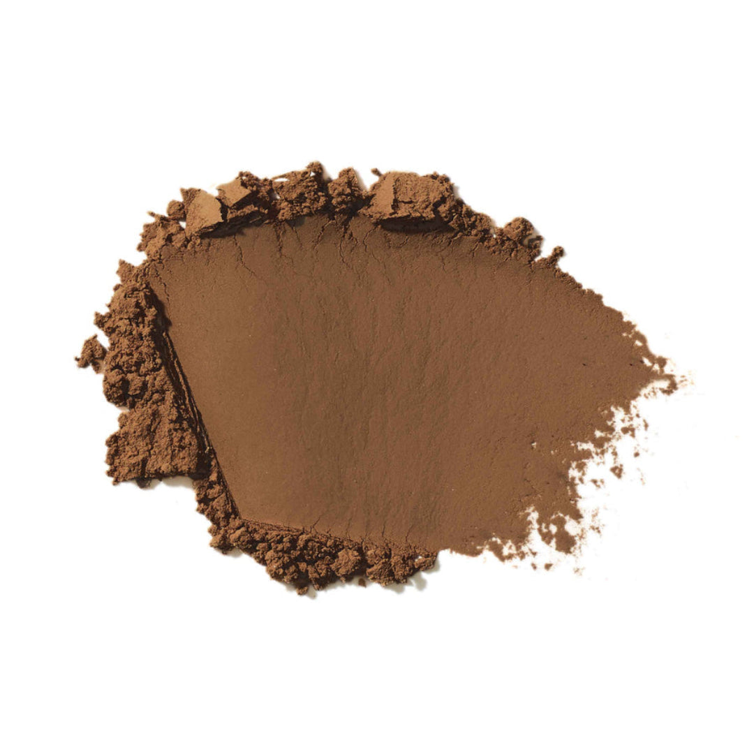 A mound of finely ground brown cosmetic powder, likely a face or body pigment, eyeshadow, or bronzer, photographed on a clean white background.