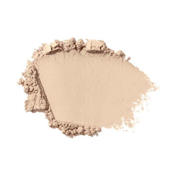 Beige makeup powder on a white background