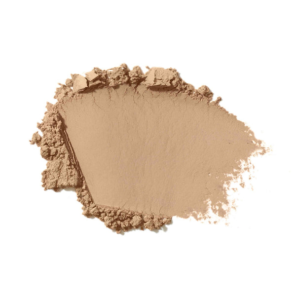 Beige makeup powder on a white background