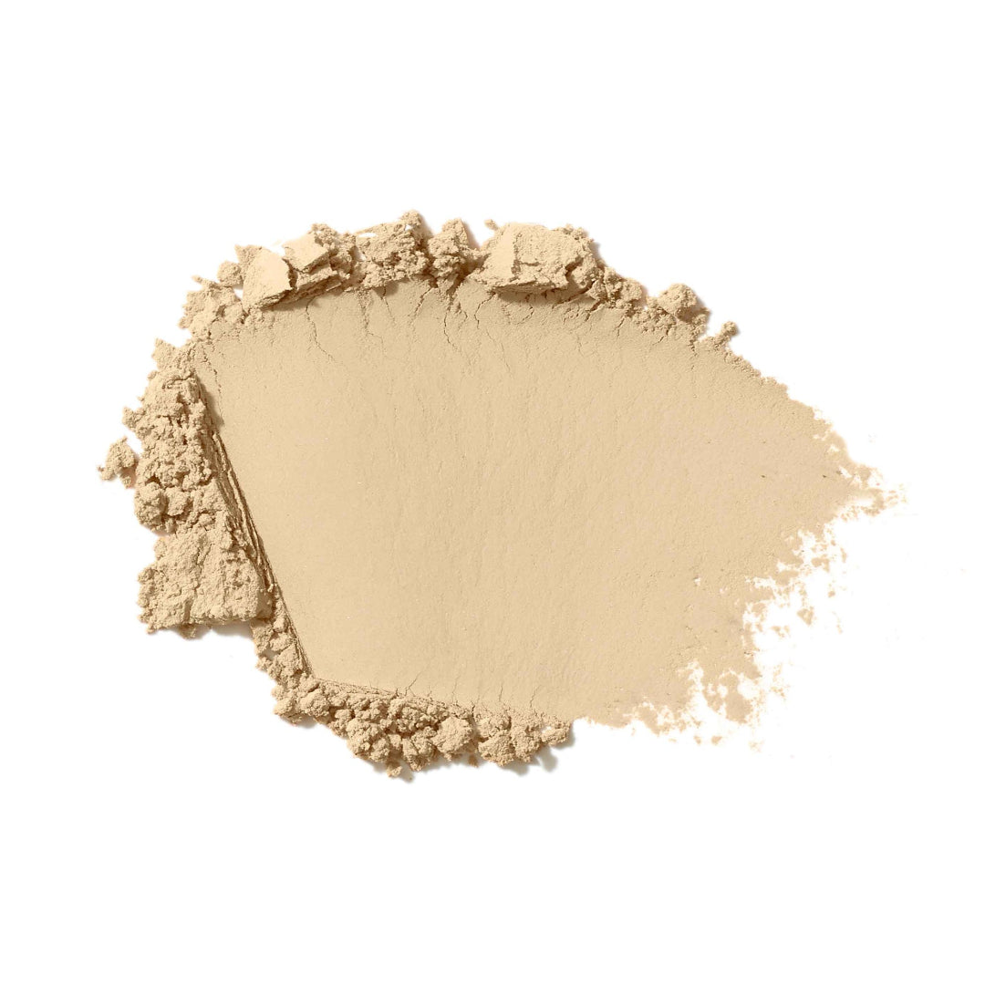 Light pink makeup powder on a white background