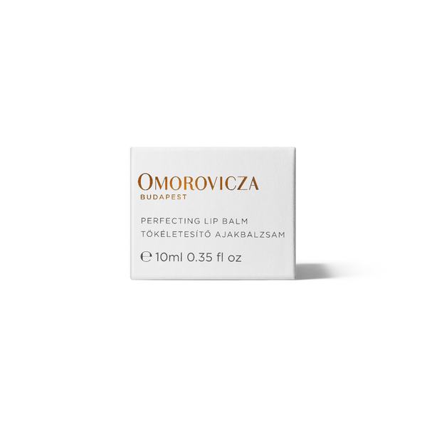 A white rectangular box of Omorovicza Perfecting Lip Balm, featuring gold and black text on a clean white background with a soft shadow.