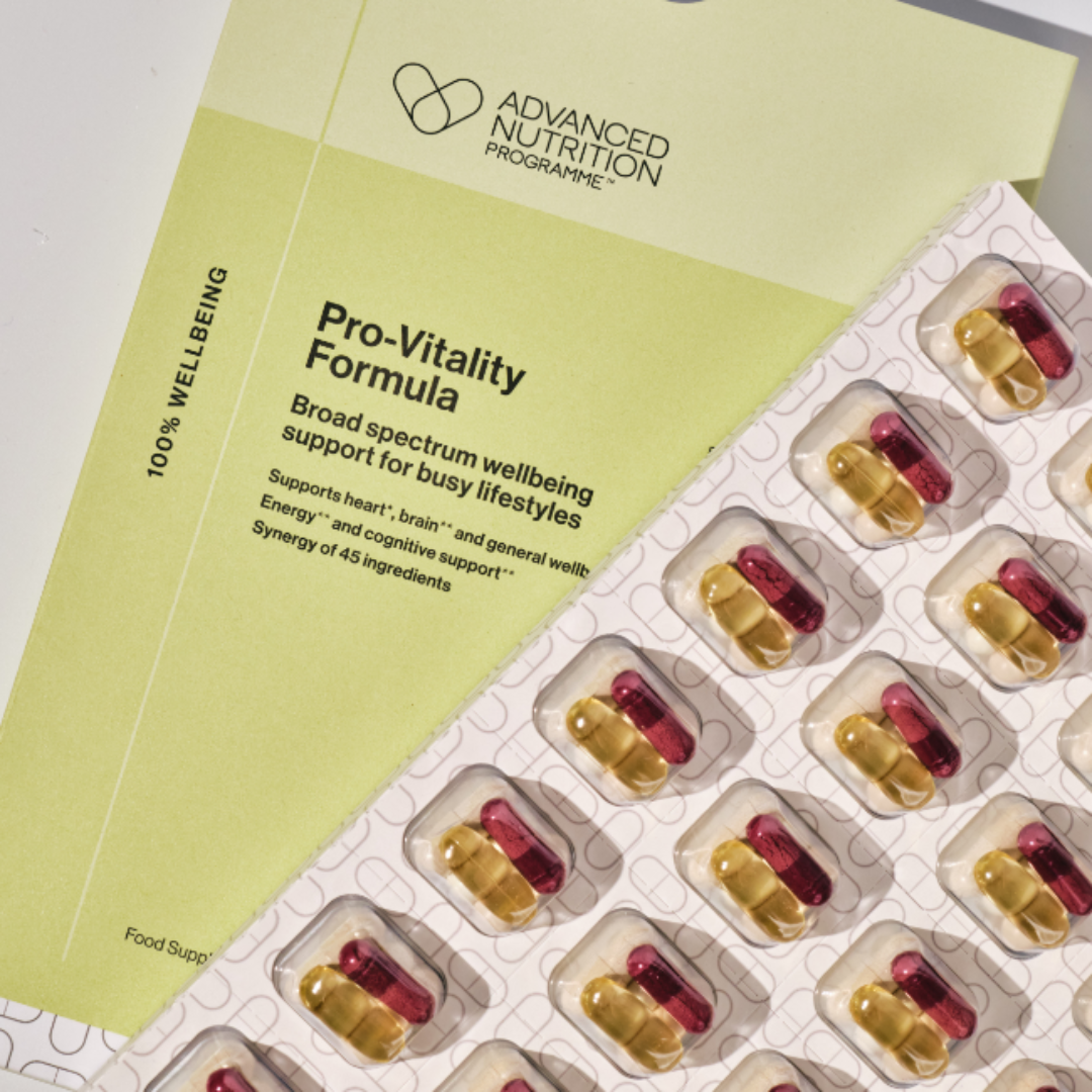 Vitamins in packaging with Advanced Nutrition Programme leaflet on a light gray background