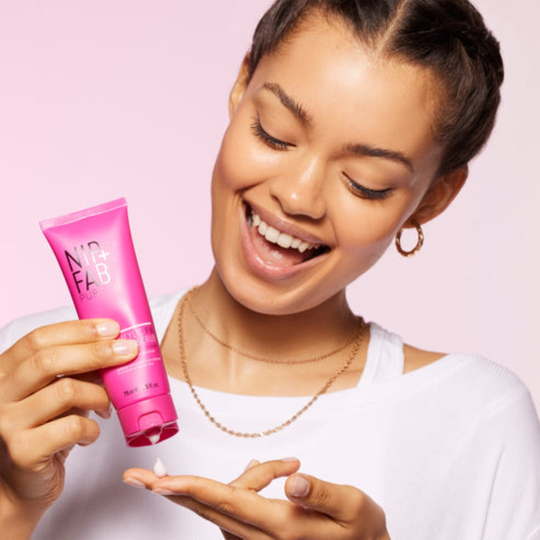 a model applying the scrub to her hand