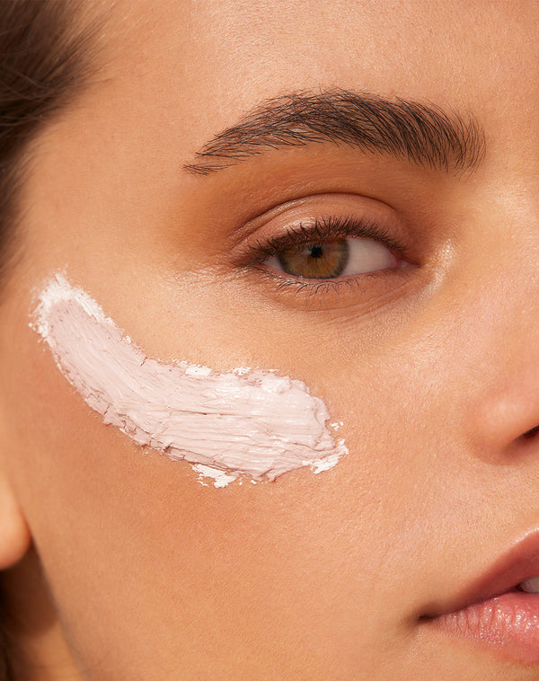 Model applying the facemask to her face