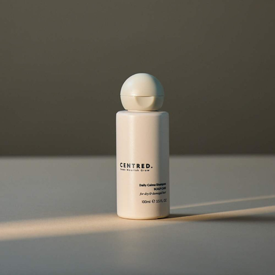 White bottle with a beige cap on a gray background