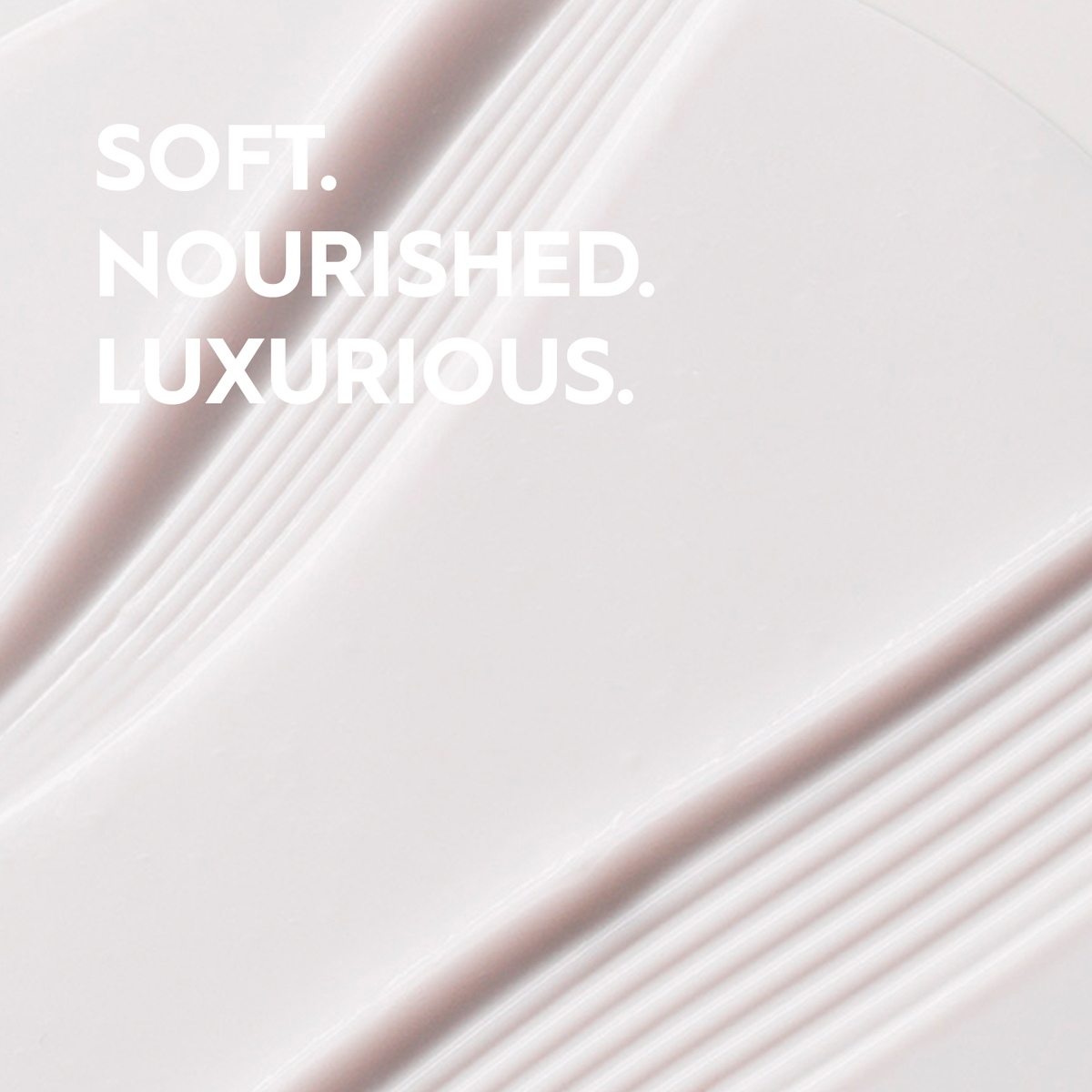 Text 'SOFT. NOURISHED. LUXURIOUS.' on a soft, gradient background.