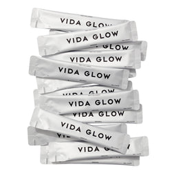 Stack of Vida Glow packets on a white background