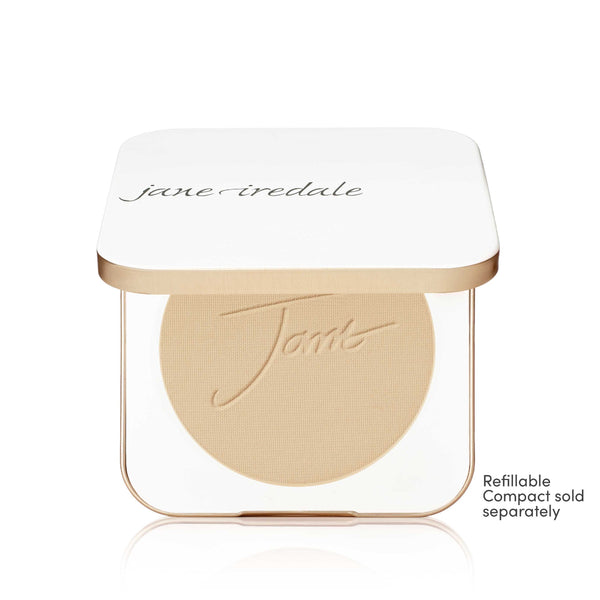 A Jane Iredale makeup compact with a white lid and gold trim, showing a round beige pressed powder pan inside. Small text on the bottom right reads 'Refillable Compact sold separately'.