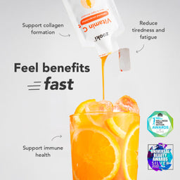 Orange juice being poured with a vitamin C supplement packaging above, on a light gray background.