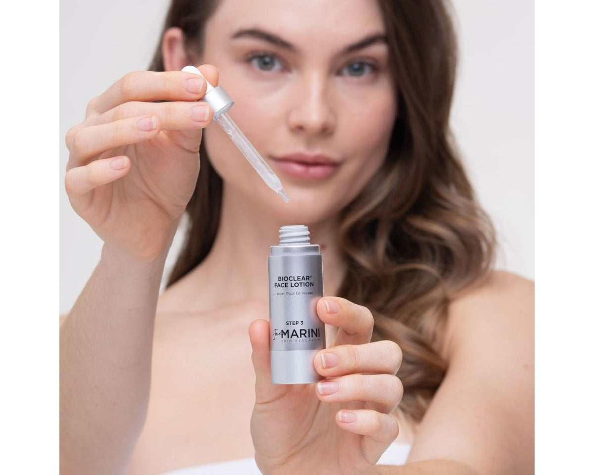 model holding a bottle of the lotion