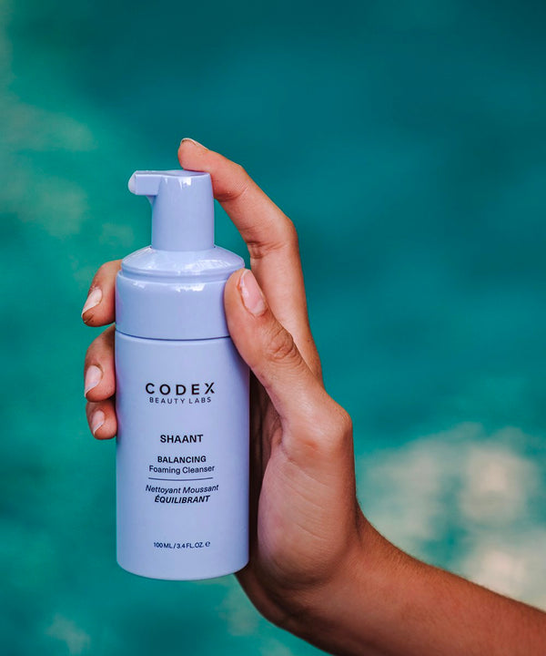 Model holding Codex Labs Shaant Balancing Cleanser