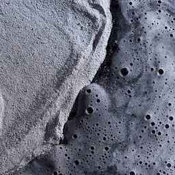 Close-up of textured gray and black material with a rough surface.