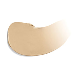 Gold-colored makeup swatch on a white background