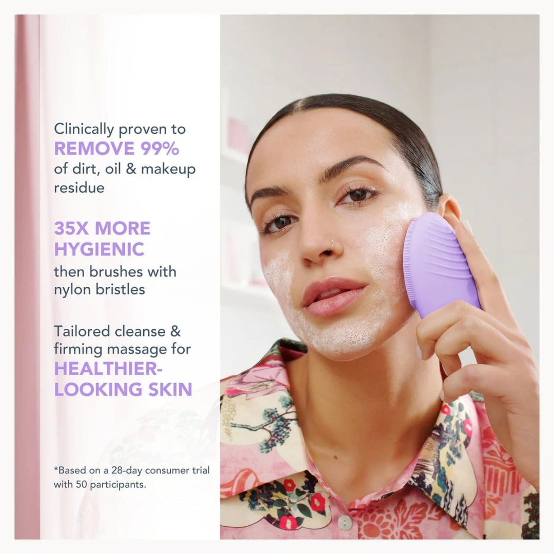 A woman with white cleanser foam on her face holds a purple silicone cleansing brush against her cheek. The left side features promotional text highlighting the product's clinical efficacy, 35x more hygiene, and tailored cleansing benefits.