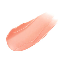 Peach-colored lip balm swatch on a white background