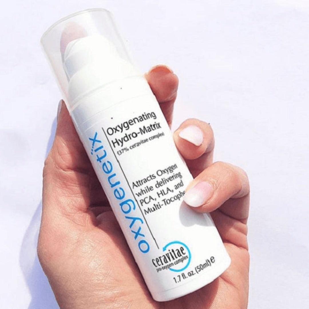 a bottle of Oxygenetix Oxygenating Hydro-Matrix held in a hand