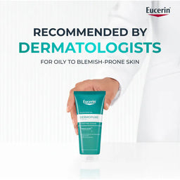 Eucerin Dermopure scrub held by a hand with a white background