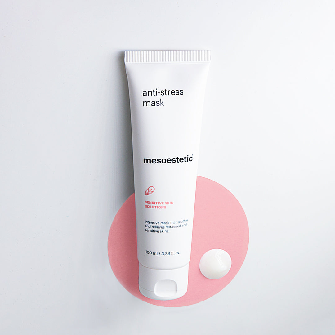 A tube of mesoestetic Anti-Stress Mask on a pink circle and dot of the cream