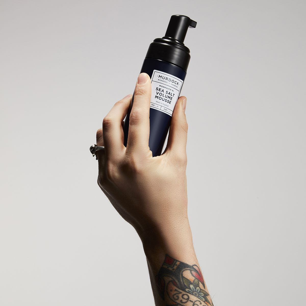 Murdock London Sea Salt Volume Mousse held in the aur